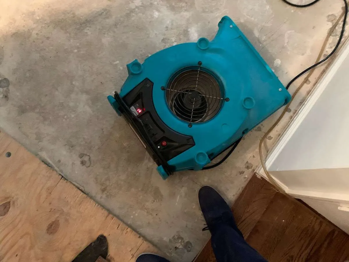 Air mover drying subfloor during Leak Detection & Repair in Badger